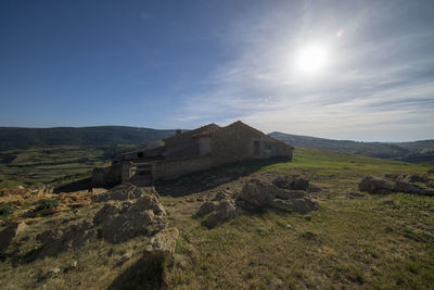 Houses on field against sky