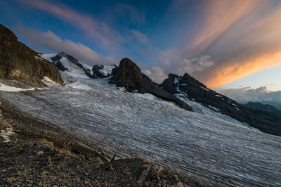 Scenic view of snowcapped mountains against sky during sunset