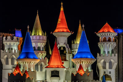 High angle view of illuminated building against sky at night