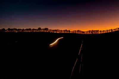 Silhouette city against sky during sunset