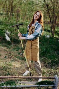 Full length of young woman standing on field