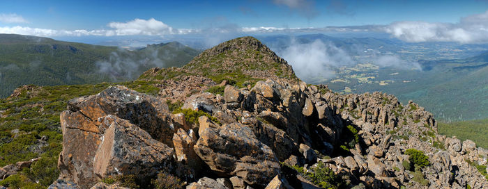 Panoramic view of dolerite rocky mountains against sky with wispy clouds