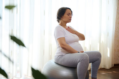 Young woman exercising at home