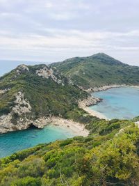 Scenic view of sea and mountains against sky