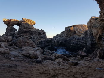 Low angle view of rock formation against sky