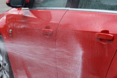 Close-up of wet red car
