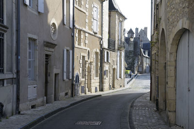 Narrow street amidst buildings in city