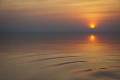 Scenic view of sea against romantic sky at sunset