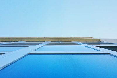 Low angle view of buildings against clear blue sky