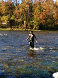 Full length of woman jumping in water