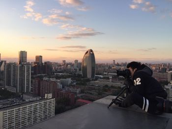 Man sitting in city