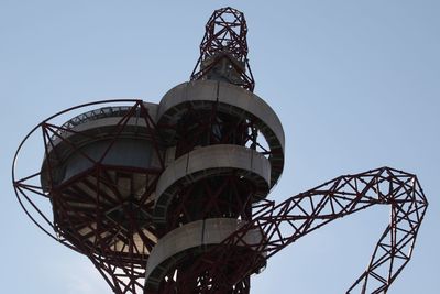 Low angle view of ferris wheel against blue sky