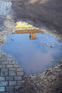 High angle view of wet puddle on street