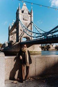 Rear view of woman standing on bridge