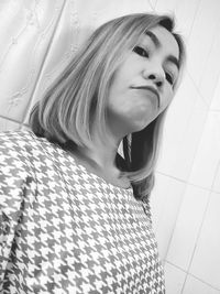 Portrait of young woman looking at home