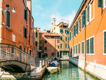 Boats moored by buildings