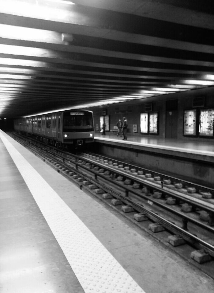 railroad station platform, rail transportation, railroad station, public transportation, railroad track, transportation, indoors, train - vehicle, subway station, travel, illuminated, subway, passenger train, public transport, train, railway station, railway station platform, mode of transport, ceiling, transportation building - type of building