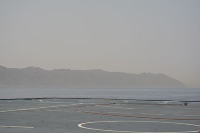 Scenic view of sea with mountain range in background