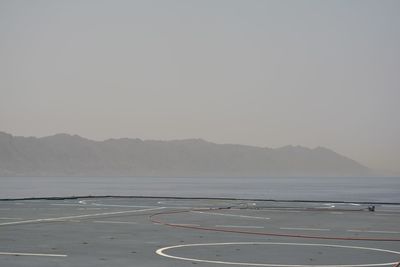 Scenic view of sea with mountain range in background