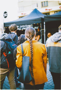 Rear view of people walking in city