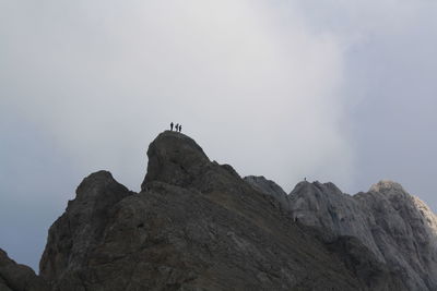 Low angle view of rock formation against sky