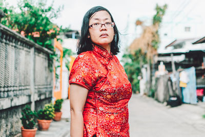 Portrait of beautiful young woman standing outdoors
