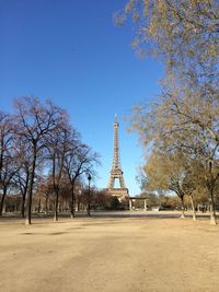 View of tower and trees against blue sky
