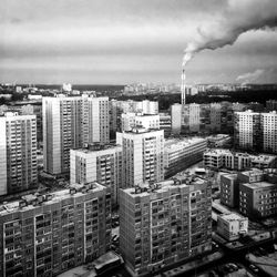 Cityscape against cloudy sky