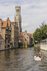 People in front of buildings against sky