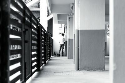 Rear view of man walking on corridor