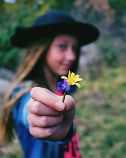 Close-up of hand holding flower