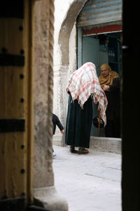 Woman standing in front of building