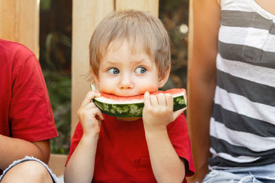 Portrait of cute boy eating food