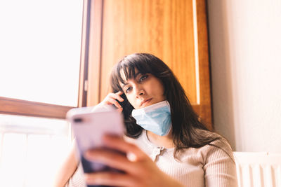 Portrait of young woman using mobile phone