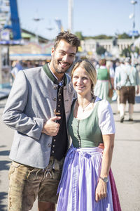 Portrait of young couple standing outdoors