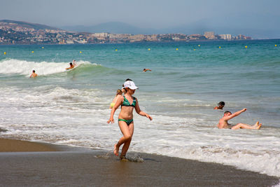 People jumping in sea