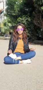 Portrait of young woman sitting outdoors