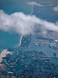 Aerial view of smoke emitting from city against sky