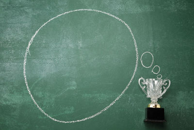 Award with speech bubble on blackboard