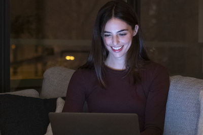 Young woman using laptop at home