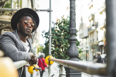 Full length portrait of young man in city