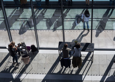 High angle view of people sitting at window in modern building