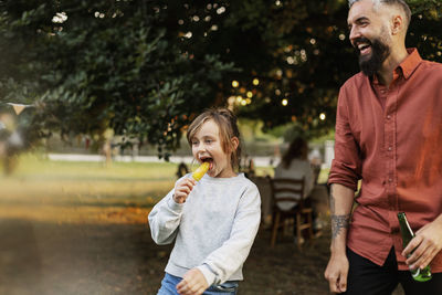 Rear view of man eating food