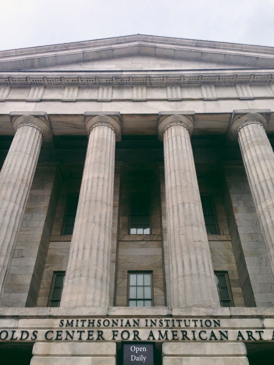 architecture, built structure, building exterior, low angle view, text, western script, city, building, window, architectural column, sky, clear sky, day, facade, outdoors, communication, no people, travel destinations, non-western script, history