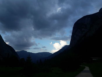 Silhouette of mountain against cloudy sky