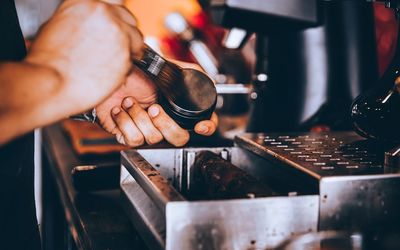 Cropped hand of man holding coffee