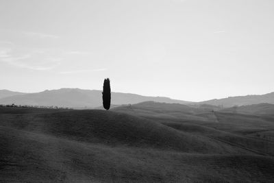 Scenic view of land and mountains against sky