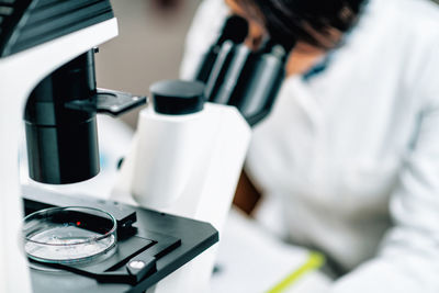 Microplastics laboratory research. scientist using a microscope 