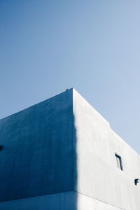 Low angle view of built structure against clear blue sky