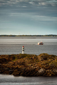 Lighthouse, fishing boat and a wind farm, flemsøya, Ålesund, norway